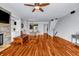 Open-concept living room with hardwood floors, fireplace and built-in shelving at 1829 Appaloosa Mill Ct, Buford, GA 30519