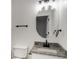 Bathroom featuring a round mirror above a granite-topped vanity with black fixtures at 2864 Parkway Close, Lithonia, GA 30058