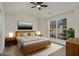 Bright bedroom featuring a large window, modern ceiling fan, and neutral decor at 2864 Parkway Close, Lithonia, GA 30058