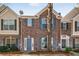 Brick facade townhome features a lovely blue door and trimmed windows at 2864 Parkway Close, Lithonia, GA 30058