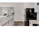 Spacious kitchen with granite island, black appliances, and view into the living area at 2864 Parkway Close, Lithonia, GA 30058
