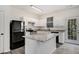 Bright kitchen with white cabinets, granite countertops, and stainless steel appliances at 2864 Parkway Close, Lithonia, GA 30058