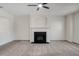 Living room featuring a fireplace, new carpet, and a ceiling fan at 2864 Parkway Close, Lithonia, GA 30058
