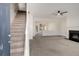 Open concept living room with a fireplace and a staircase to the upper level at 2864 Parkway Close, Lithonia, GA 30058