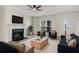 Living room featuring a fireplace, large TV, furniture and ceiling fan at 2864 Parkway Close, Lithonia, GA 30058