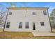 This exterior image displays the home's back side and the concrete patio at 1408 Seals Rd, Dallas, GA 30157
