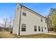 This image shows the home's back side, the air conditioner, and a portion of the yard at 1408 Seals Rd, Dallas, GA 30157