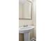 Pedestal sink with modern fixtures and a sleek mirror in a well-lit bathroom at 1408 Seals Rd, Dallas, GA 30157