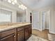 This bathroom features double sinks, wood floors, plenty of natural light, and access to the walk-in closet at 1408 Seals Rd, Dallas, GA 30157