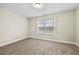 Bedroom featuring neutral carpet, window and base trim at 1408 Seals Rd, Dallas, GA 30157