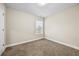 Bedroom featuring neutral carpet, window and base trim at 1408 Seals Rd, Dallas, GA 30157