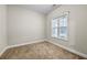 Neutral bedroom with a window, providing ample natural light, and neutral carpeting at 1408 Seals Rd, Dallas, GA 30157