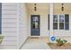 Welcoming front entrance with elegant lighting fixtures and a secure ADT security system at 1408 Seals Rd, Dallas, GA 30157