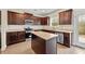 Modern kitchen featuring stainless steel appliances, granite counters and dark wood cabinets at 1408 Seals Rd, Dallas, GA 30157