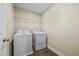 Laundry Room featuring a white washer, dryer and wire shelving for ample storage at 1408 Seals Rd, Dallas, GA 30157