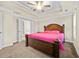 This is an alternate angle of the main bedroom, displaying its neutral colors, ceiling fan, and trey ceiling at 1408 Seals Rd, Dallas, GA 30157