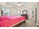 This main bedroom features a trey ceiling, ceiling fan, dresser, and access to the en suite bathroom at 1408 Seals Rd, Dallas, GA 30157