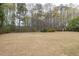 Wide shot of large backyard surrounded by mature trees with a storage shed at 2555 Stonevalley Ln, Cumming, GA 30041