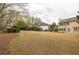 Large backyard featuring a well-manicured lawn with mature trees at 2555 Stonevalley Ln, Cumming, GA 30041