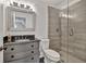 Modern bathroom featuring a glass enclosed shower, gray vanity and granite countertops at 2555 Stonevalley Ln, Cumming, GA 30041