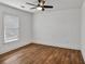 Neutral bedroom with ceiling fan, window, and crisp white trim at 2555 Stonevalley Ln, Cumming, GA 30041