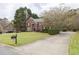 Beautiful brick home with mature landscaping and a long driveway at 2555 Stonevalley Ln, Cumming, GA 30041