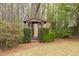 Landscaped backyard featuring a charming gazebo in a wooded area of the property at 2555 Stonevalley Ln, Cumming, GA 30041