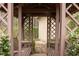 Cozy gazebo interior featuring built-in benches and views of the garden shed at 2555 Stonevalley Ln, Cumming, GA 30041