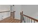 Upstairs hallway boasts wood railing with black iron spindles and neutral paint at 2555 Stonevalley Ln, Cumming, GA 30041