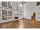 Bright living room features hardwood floors, fireplace, and large windows with lots of natural light at 2555 Stonevalley Ln, Cumming, GA 30041