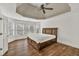 Spacious main bedroom with hardwood floors and a tray ceiling with a ceiling fan at 2555 Stonevalley Ln, Cumming, GA 30041