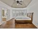 Bright main bedroom featuring a bay window, tray ceiling, and a doorway leading to an ensuite bathroom at 2555 Stonevalley Ln, Cumming, GA 30041