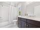 Bathroom with dark wood vanity, marble countertop, subway tile shower, and white fixtures at 2877 Elliott Ne Cir, Atlanta, GA 30305