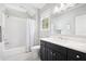 Bright bathroom with white subway tile, tub, and dark vanity with a marble countertop at 2877 Elliott Ne Cir, Atlanta, GA 30305