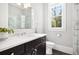 Bright bathroom with marble countertops, dark wood cabinets, and glass-enclosed shower at 2877 Elliott Ne Cir, Atlanta, GA 30305