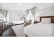 Bedroom with hardwood floors, two twin beds, patterned armchair and two windows at 2877 Elliott Ne Cir, Atlanta, GA 30305
