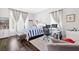 Bedroom with two windows, hardwood floors, striped bedspread, gray armchair, and desk with computer setup at 2877 Elliott Ne Cir, Atlanta, GA 30305