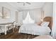 Bedroom with hardwood floors, neutral walls, wicker headboard, and white desk at 2877 Elliott Ne Cir, Atlanta, GA 30305