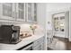Convenient coffee bar with built-in cabinets, marble countertop, and a view to the outdoors at 2877 Elliott Ne Cir, Atlanta, GA 30305