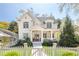 Charming white two-story home with landscaped yard, inviting front porch, and white picket fence at 2877 Elliott Ne Cir, Atlanta, GA 30305