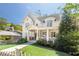Elegant two-story home with white exterior, manicured lawn, and covered front porch at 2877 Elliott Ne Cir, Atlanta, GA 30305