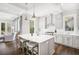 Bright, open kitchen with white cabinetry, stainless appliances, large island, and eat-in area at 2877 Elliott Ne Cir, Atlanta, GA 30305