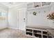 Welcoming mudroom features custom built-ins, bench seating, and stylish herringbone tile flooring at 2877 Elliott Ne Cir, Atlanta, GA 30305