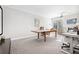 Large office space with carpet, large wooden table, and a comfortable sitting area with couch at 2877 Elliott Ne Cir, Atlanta, GA 30305