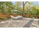 Stone patio with comfortable seating, lush landscaping, and a serene backyard setting at 2877 Elliott Ne Cir, Atlanta, GA 30305