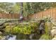 Beautiful backyard pond with waterfall feature, lush greenery, and charming decorative accents at 2877 Elliott Ne Cir, Atlanta, GA 30305