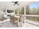 Screened porch with fireplace, tile floors, and a dining area for outdoor entertaining at 2877 Elliott Ne Cir, Atlanta, GA 30305
