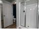 Bathroom featuring a glass door shower, toilet, and dark blue accent wall at 3894 Dunaire Dr, Stone Mountain, GA 30083