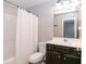 Well-lit bathroom with a shower-tub combo and a wood vanity at 3894 Dunaire Dr, Stone Mountain, GA 30083