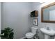 Cozy half-bathroom with modern farmhouse decor featuring a pedestal sink, and a wood-framed mirror at 3894 Dunaire Dr, Stone Mountain, GA 30083